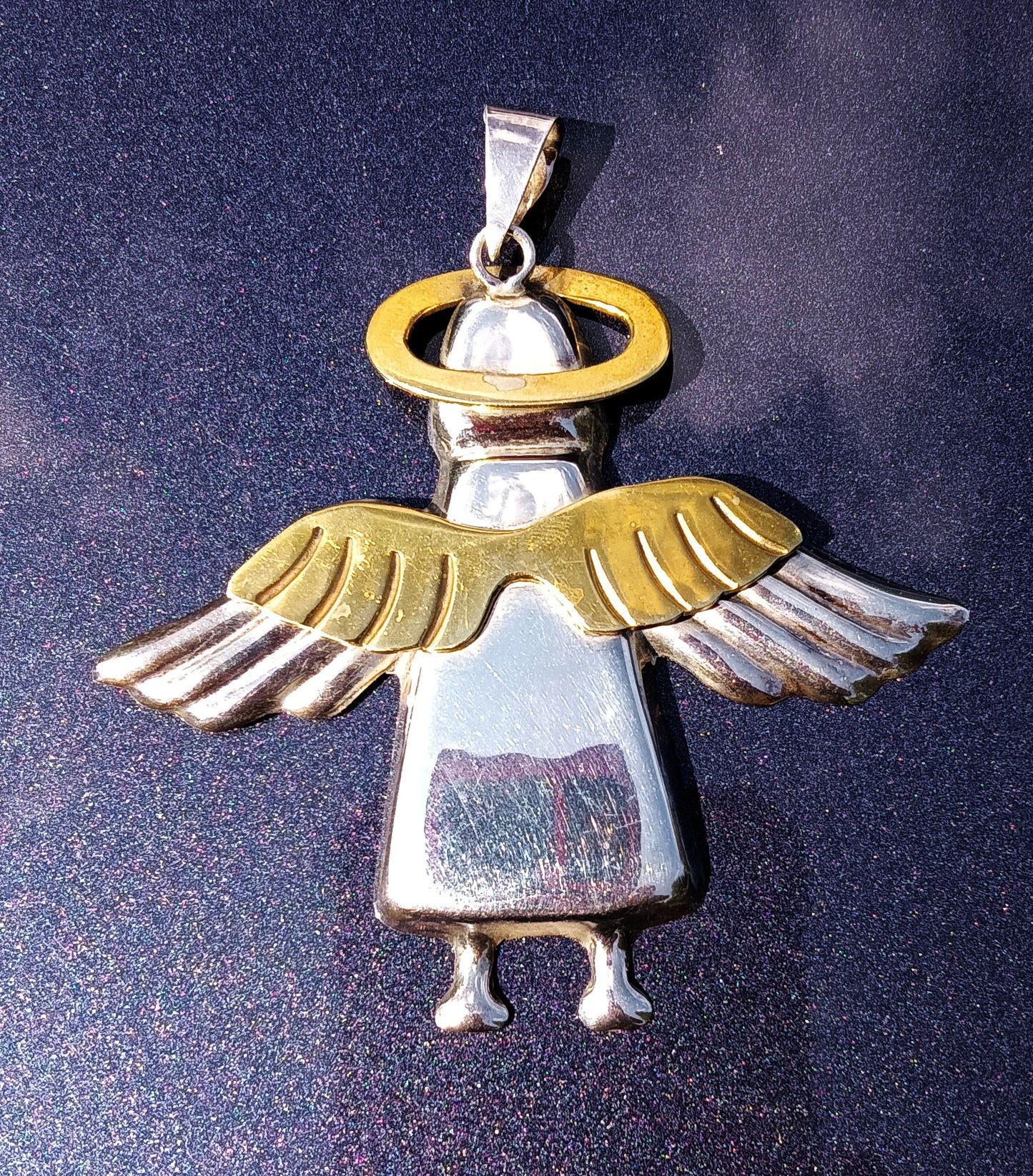 The dark part of the bottom of the angel is a camera reflection.